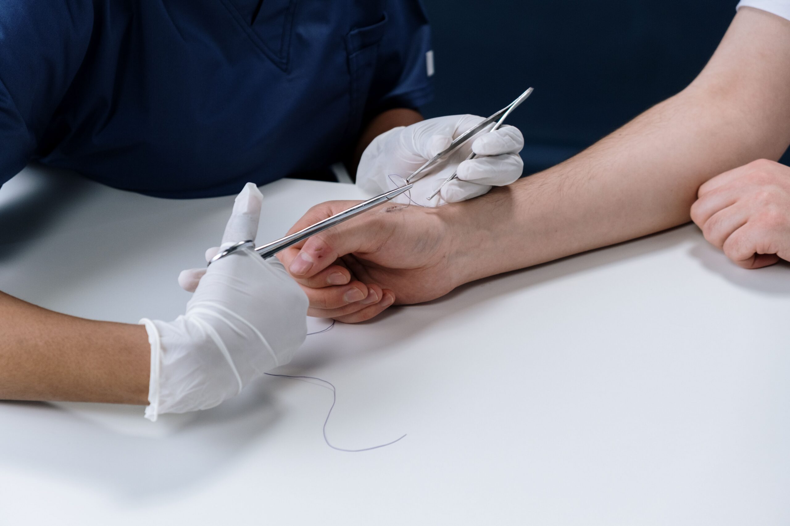 Clinician treating a patient's hand and upper limb injury